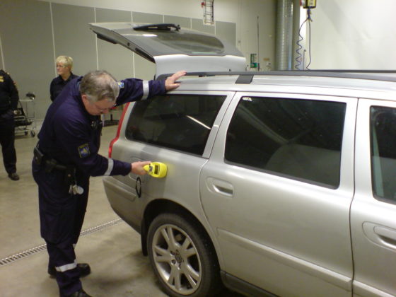 A man using a portable contraband detector