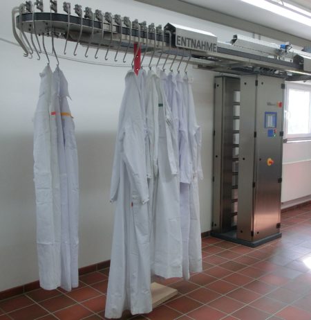 Clothes hung on a laundry contamination monitor for radiations with a running rail system