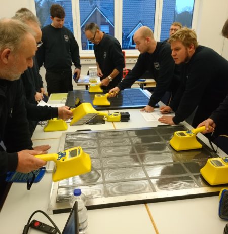 Radiation safety personnel are training by searching contamination on a drawer