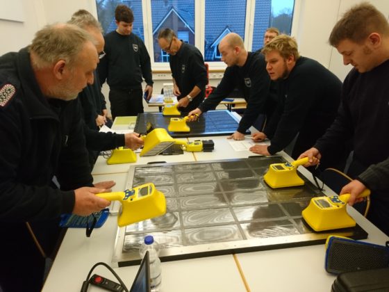 Radiation safety personnel are training by searching contamination on a drawer