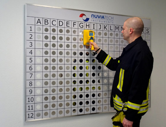 A man using an Interactive wall for staff training on radioactive source identification