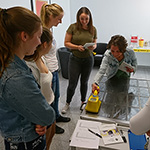 People training to use a hand-held contamination monitor