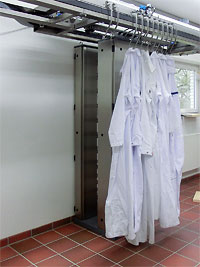 Clothes hung on a laundry contamination monitor for radiations with a running rail system