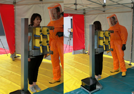 Woman using an emergency contamination monitor