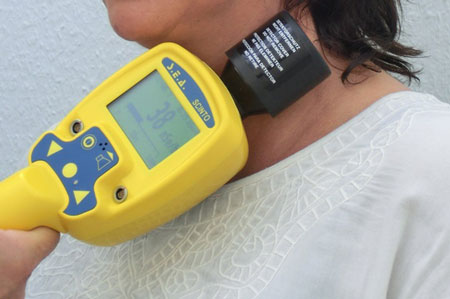 Someone using a thyroid dosimeter