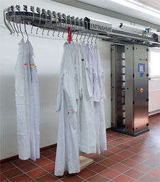 Clothes hung on a laundry contamination monitor for radiations with a running rail system