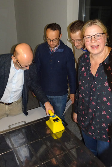 People monitoring a surface using a hand-held contamination monitor